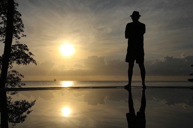 A man silhouette near the ocean on sunset