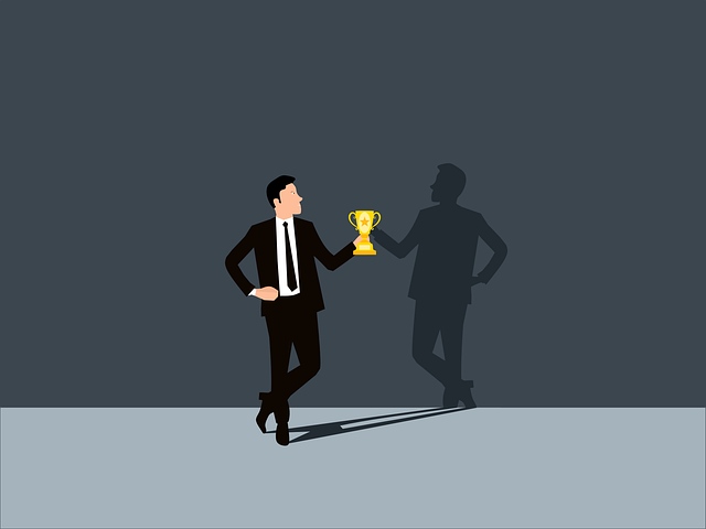 An illustration of a man with a suit holding a trophy and looking on his silhouette