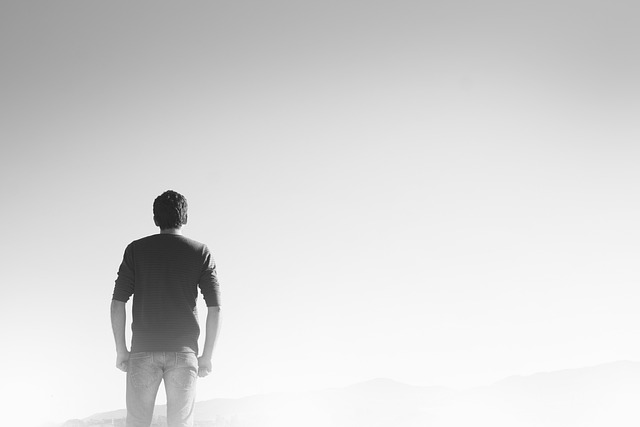 A man looking to the horizon and foggy background